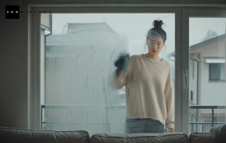 Woman trying to wipe condensation off windows