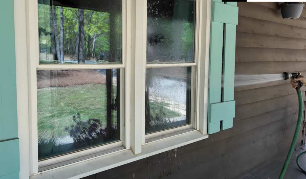 Spraying windows with water from a hose
