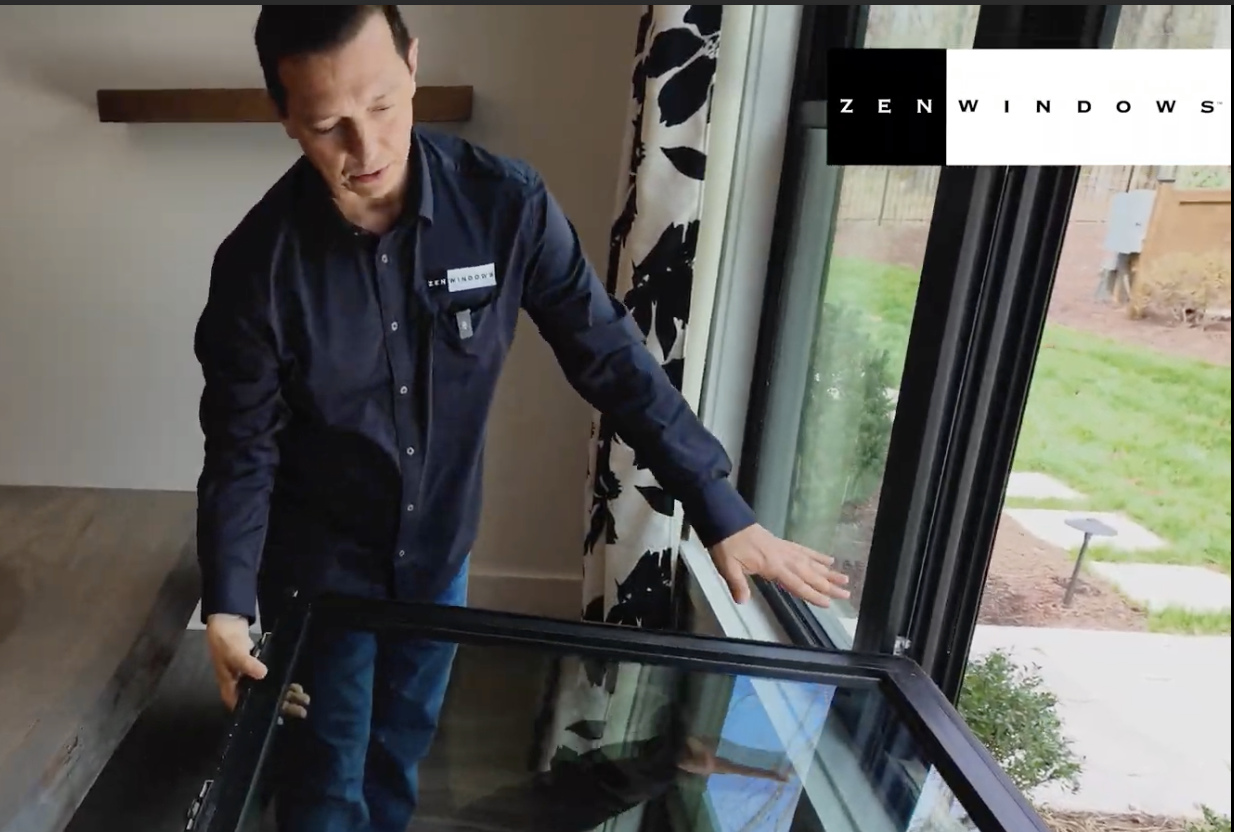 A man opening a window sash for cleaning