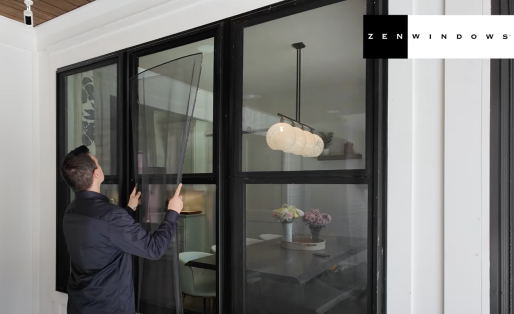 Man taking a flexscreen off a window.