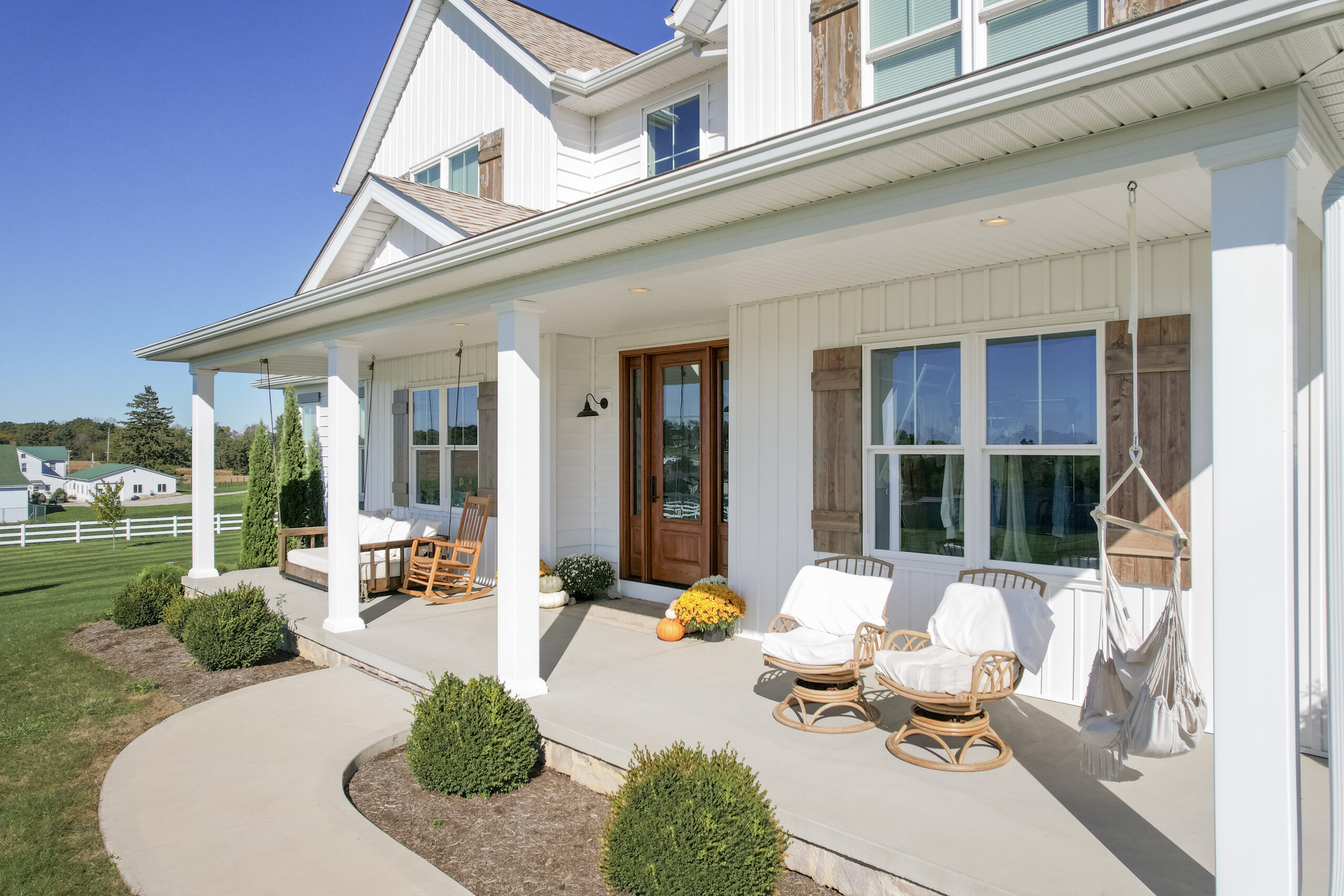White home with the sun shining on the windows