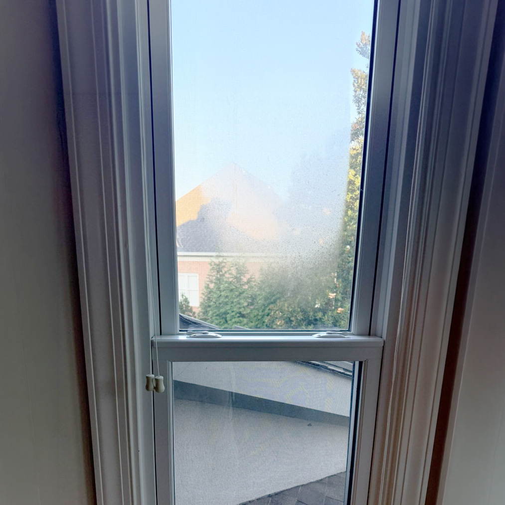 Window with condensation forming on the glass.