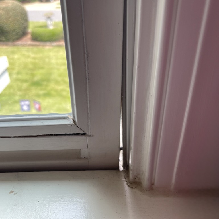 An old window that has a gap in the frame, letting outside air into the home.