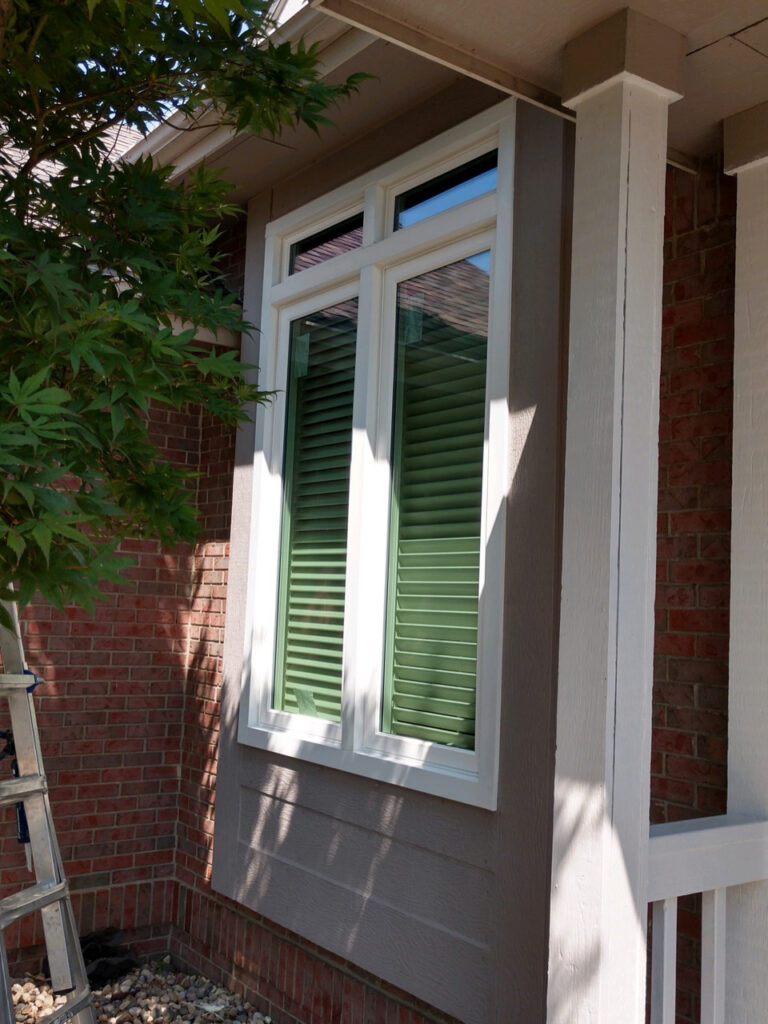 White casement windows with the sunshine showing the low-e tint.