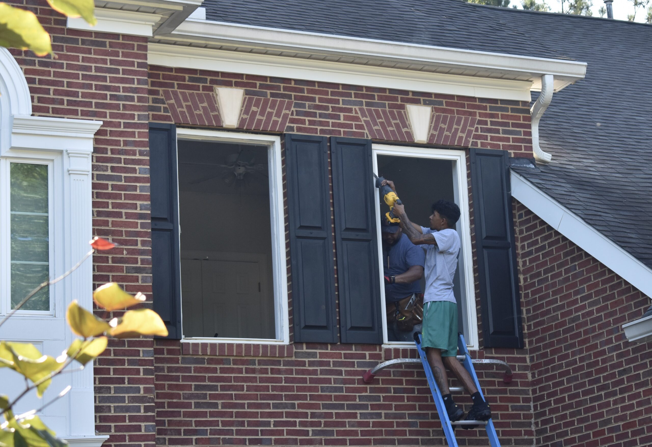 Cutting out the frame of an old window.