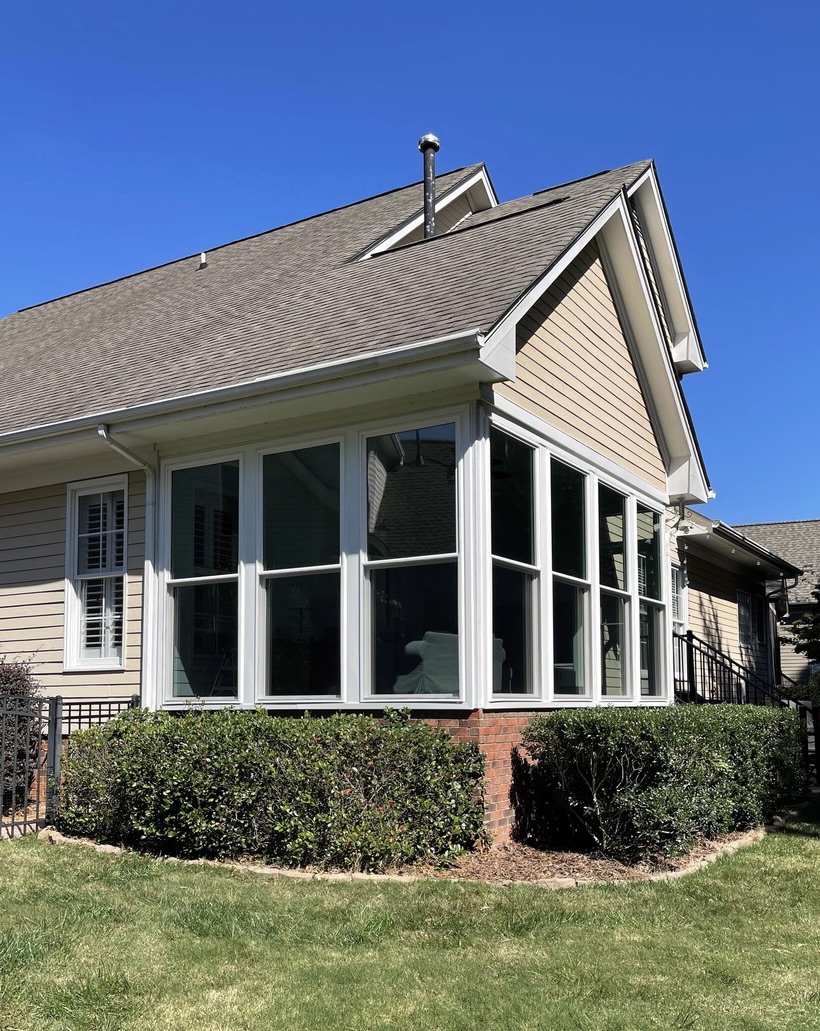 Double-hung windows on enclosed porch.