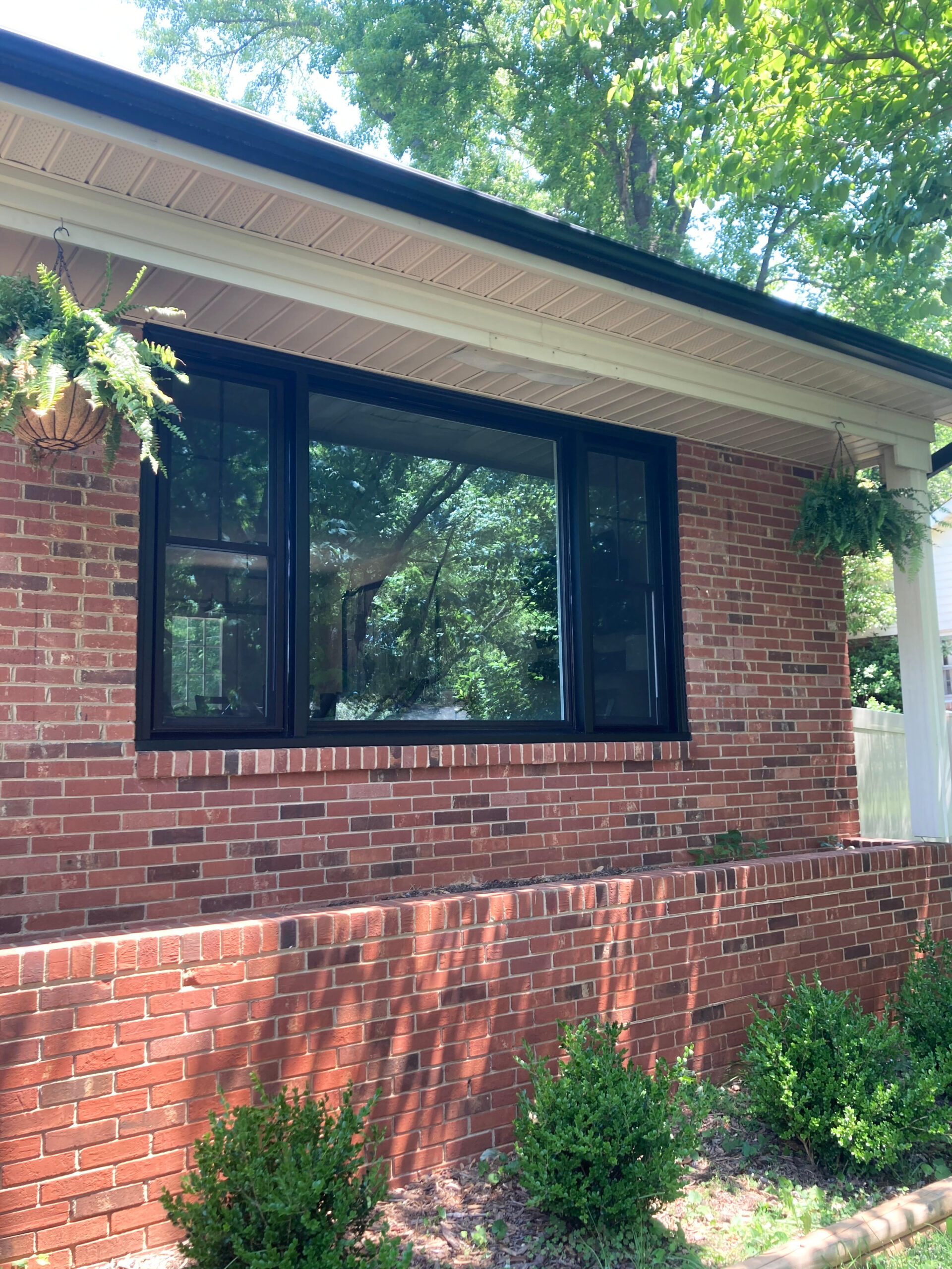 Black double-hung windows and a picture window.