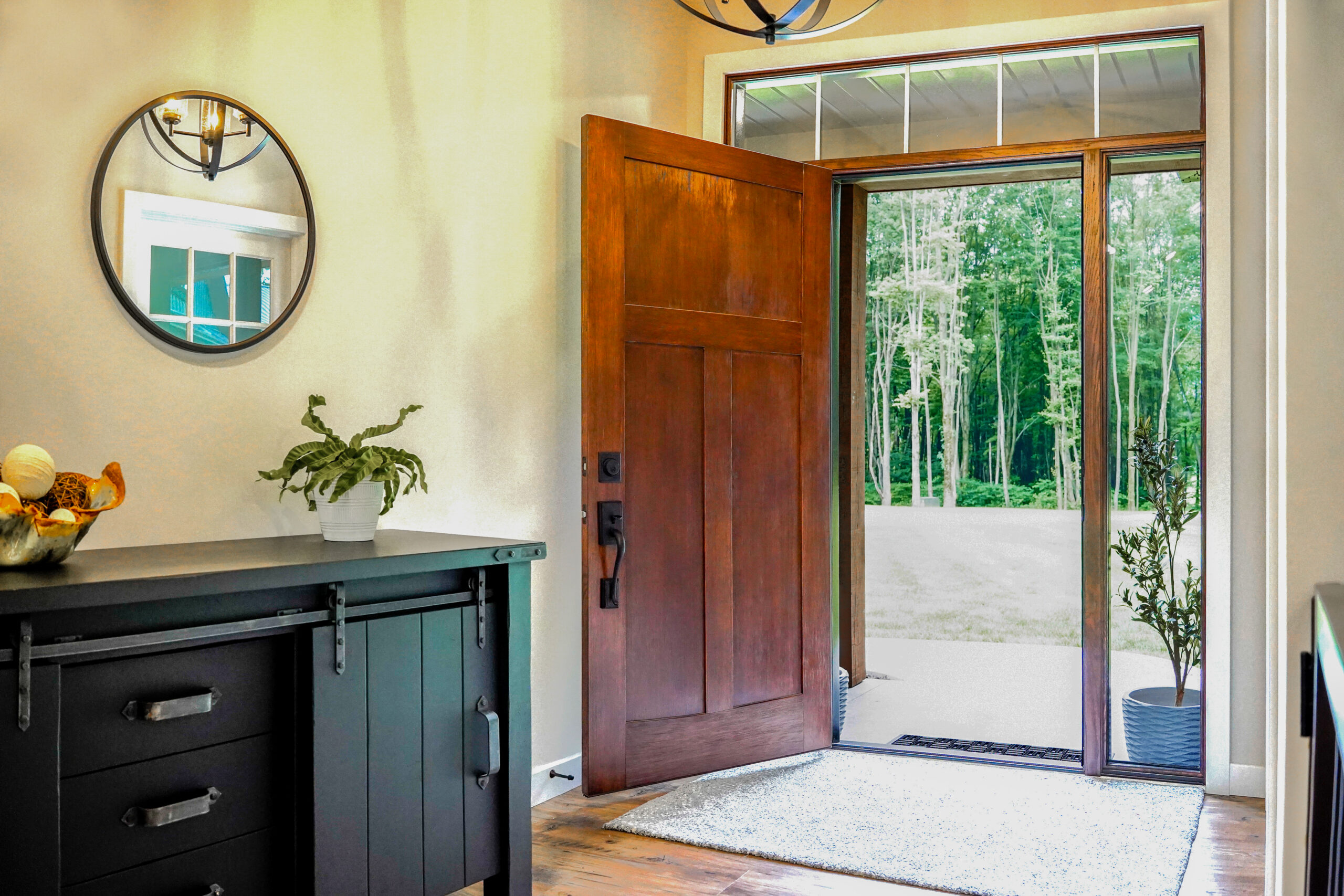 Wood entry door opened to entryway.