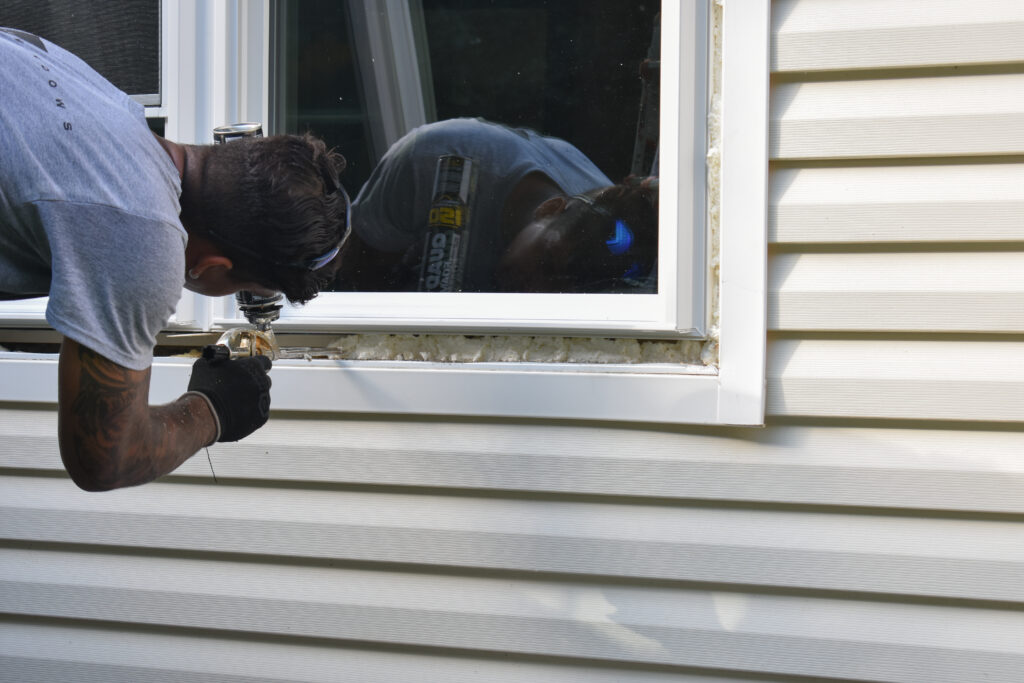 Filling the frame with foam for insulation.