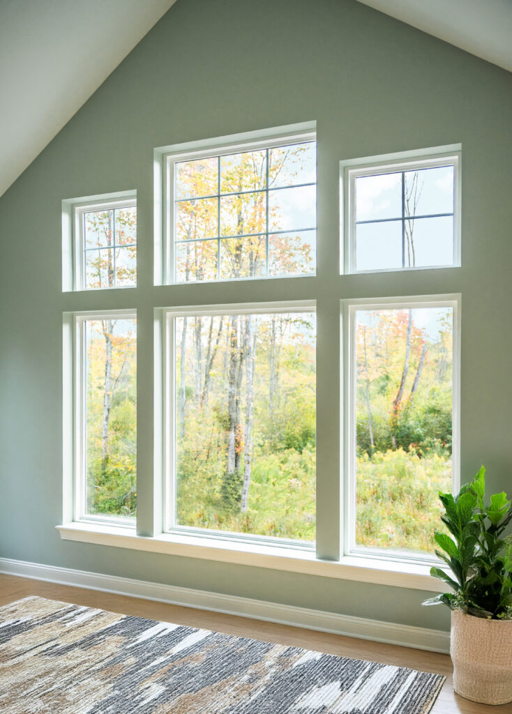 Large white picture windows with colonial and cottage style grids.