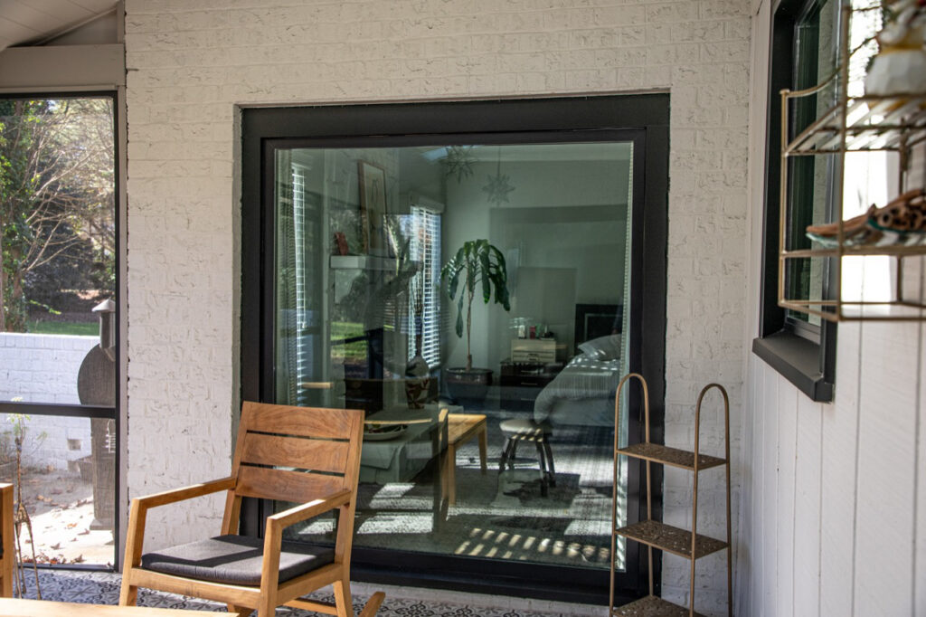 Large black picture window with view into the kitchen.