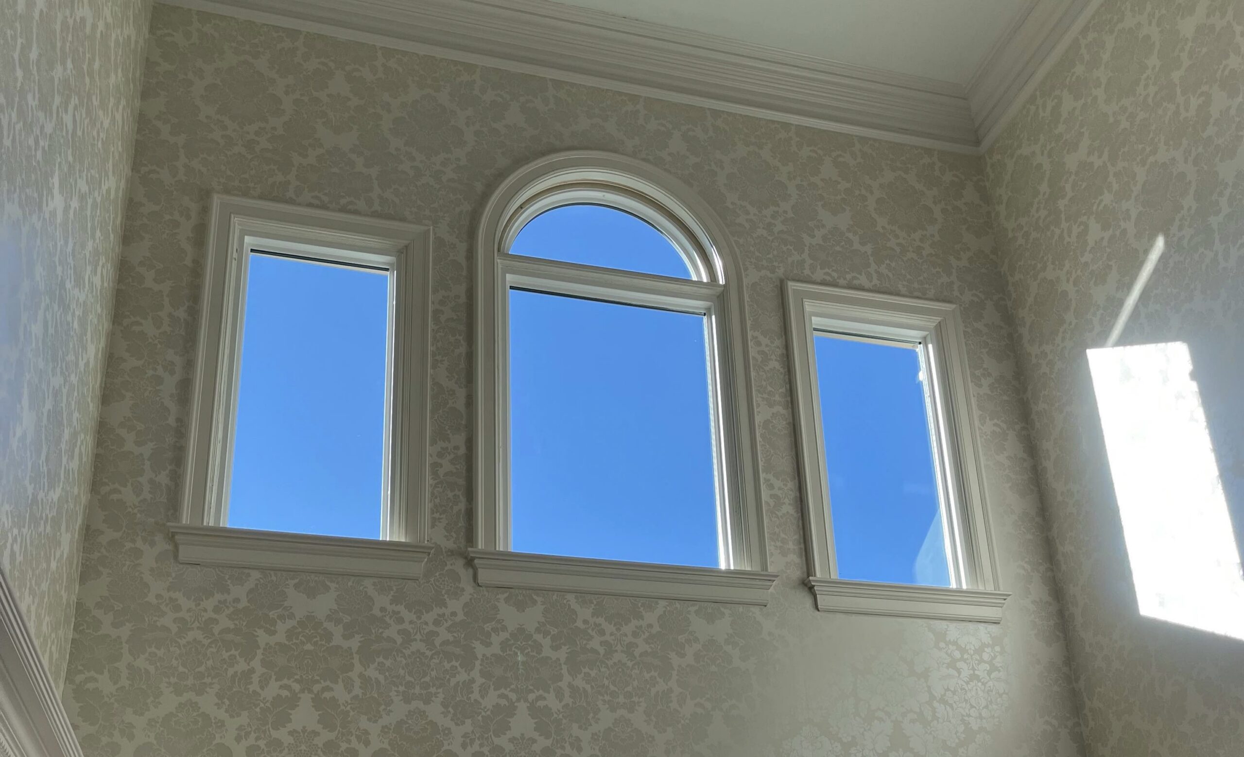 Three large picture windows with a specialty round top window.
