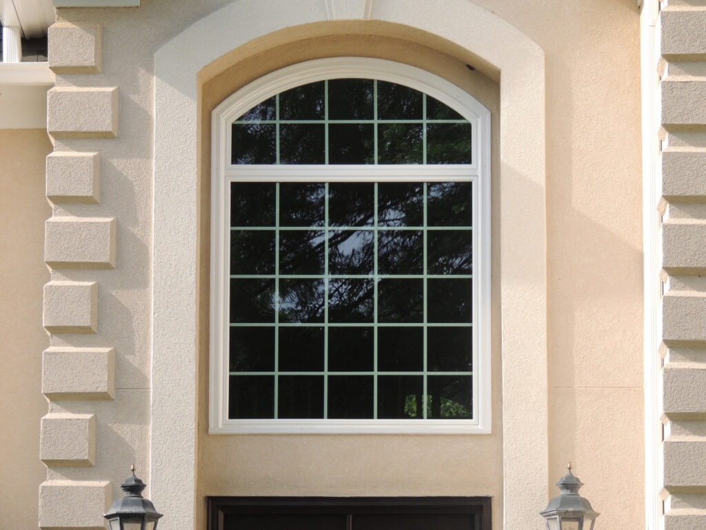 Round top window with colonial grids.