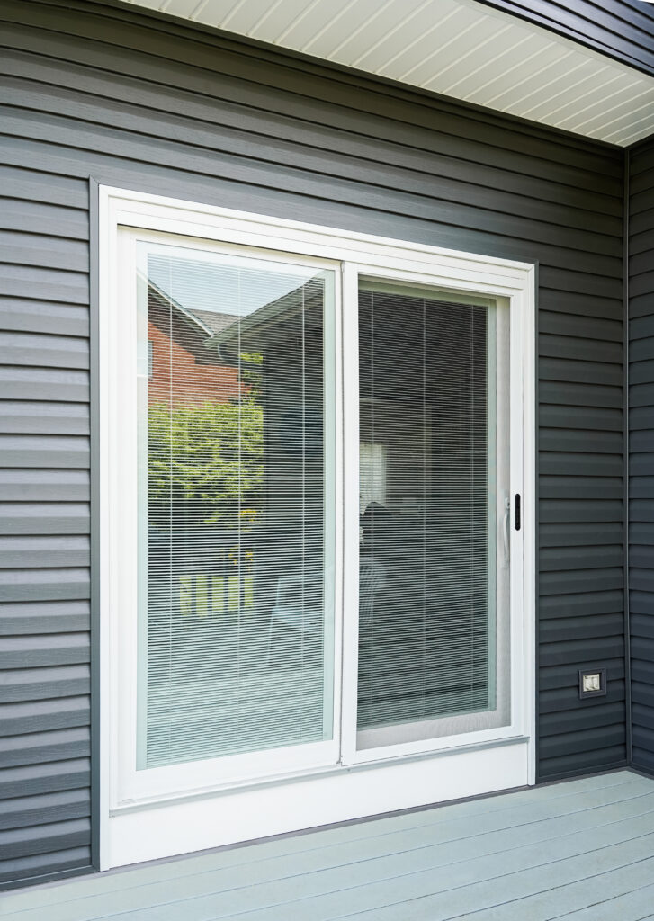 White sliding patio door with internal blinds.