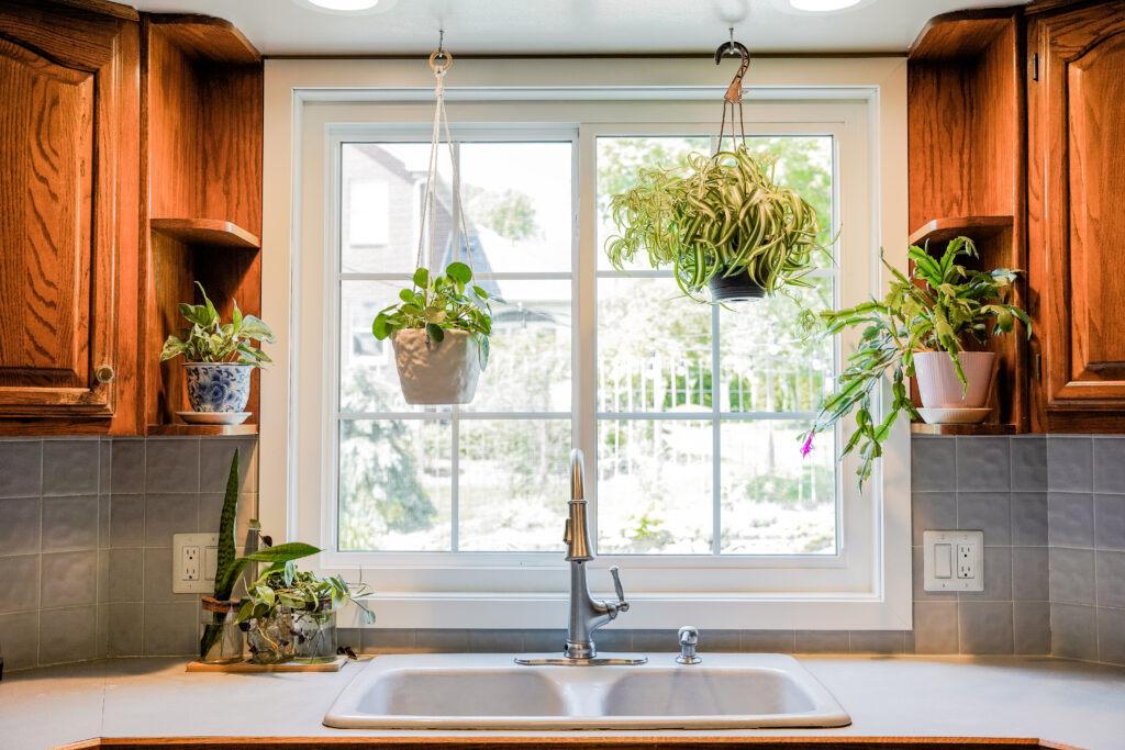 White Endure sliding window with colonial grids.