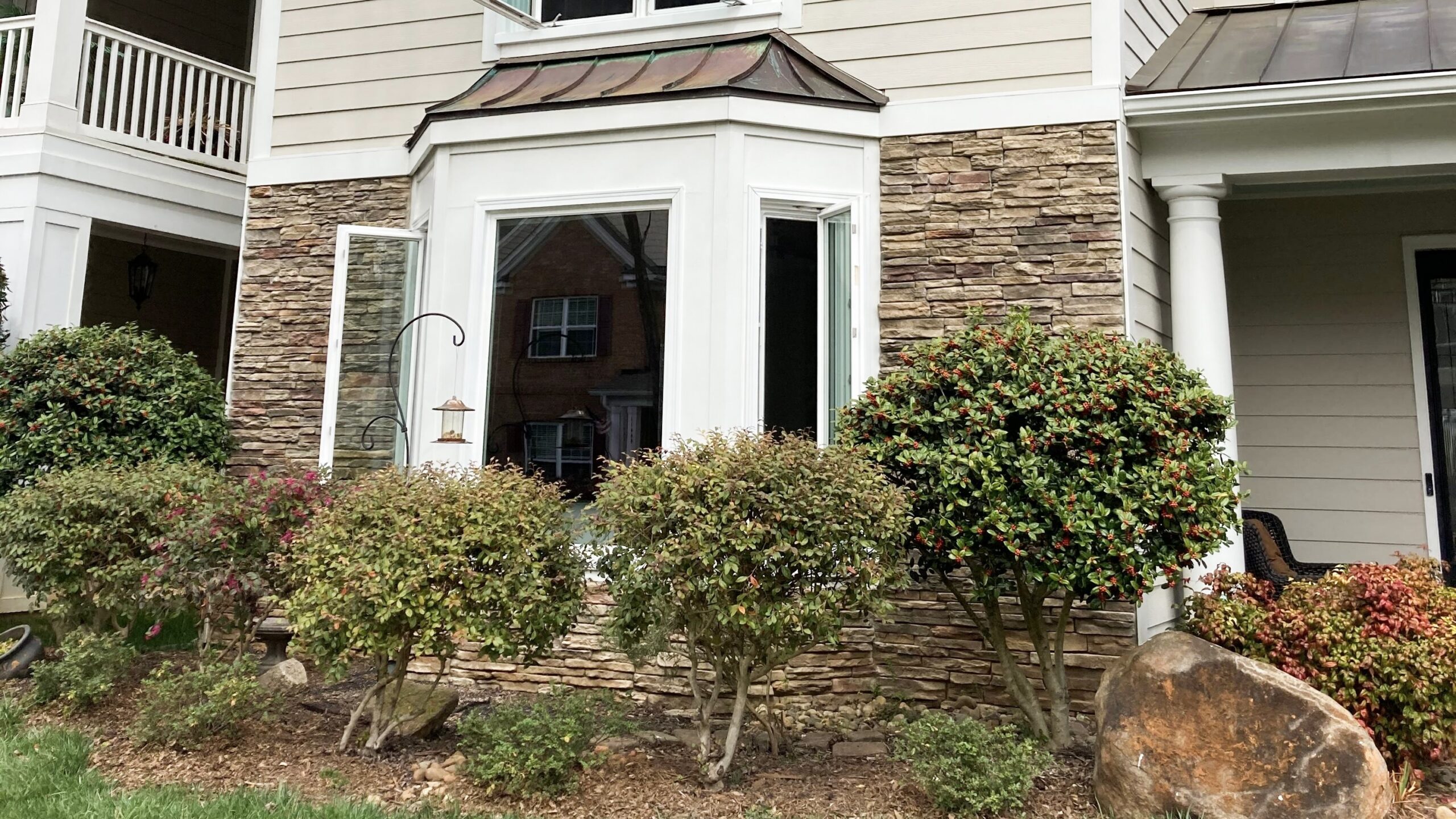 Open casement windows within bay window.