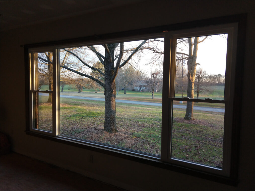 Double-hung windows and a picture window with no grids.