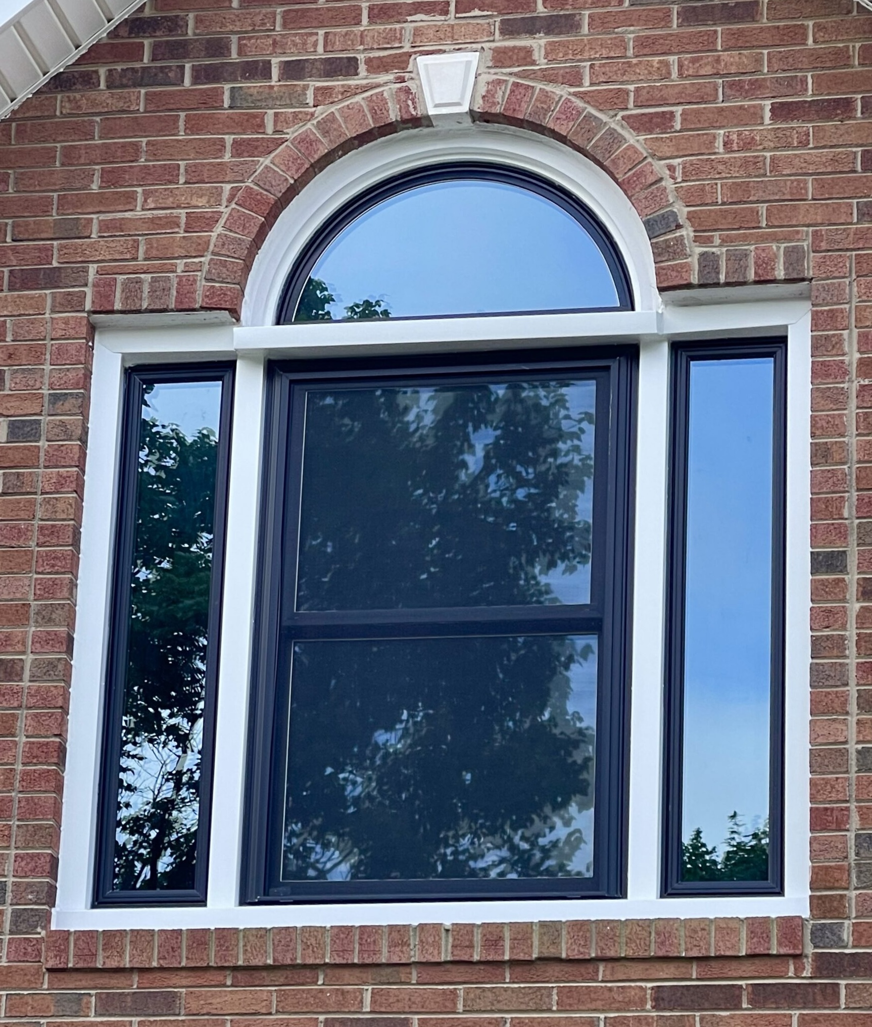 Round top window over double hung window.