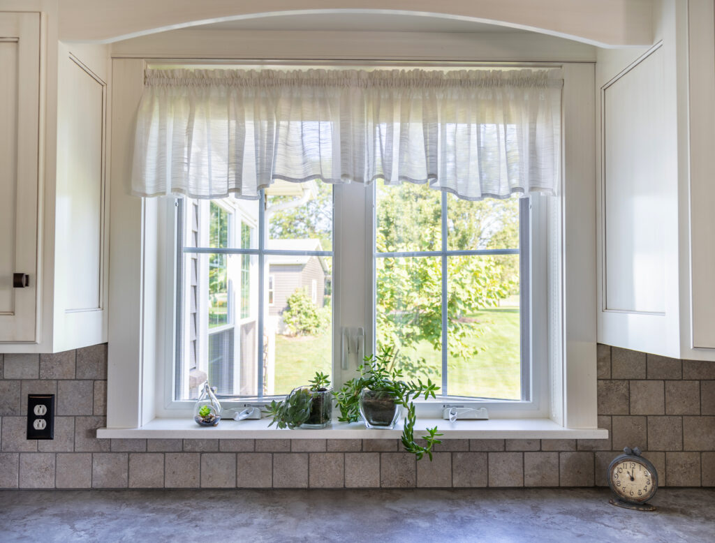 White Endure casement window with cottage grids.