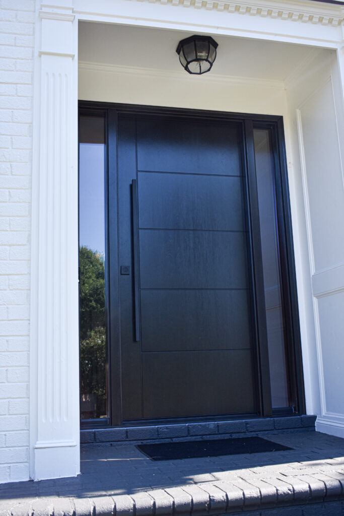 Inscribed wood-like fiberglass entry door in Ebony.
