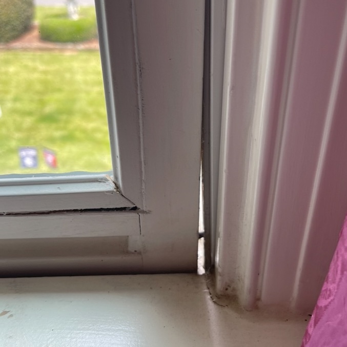 Gap in the frame of an old window.