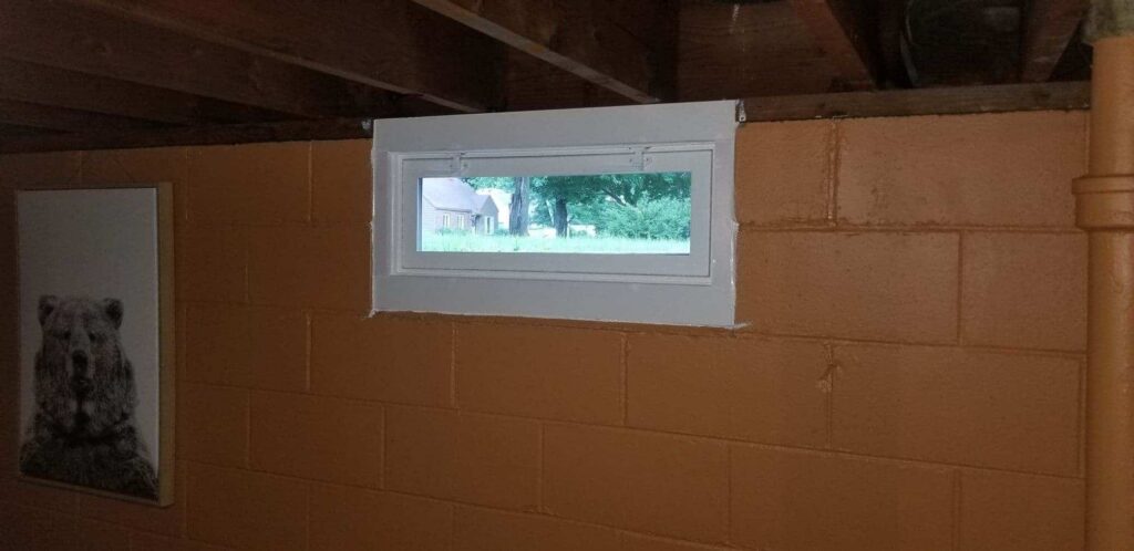 White hopper window with orange walls.