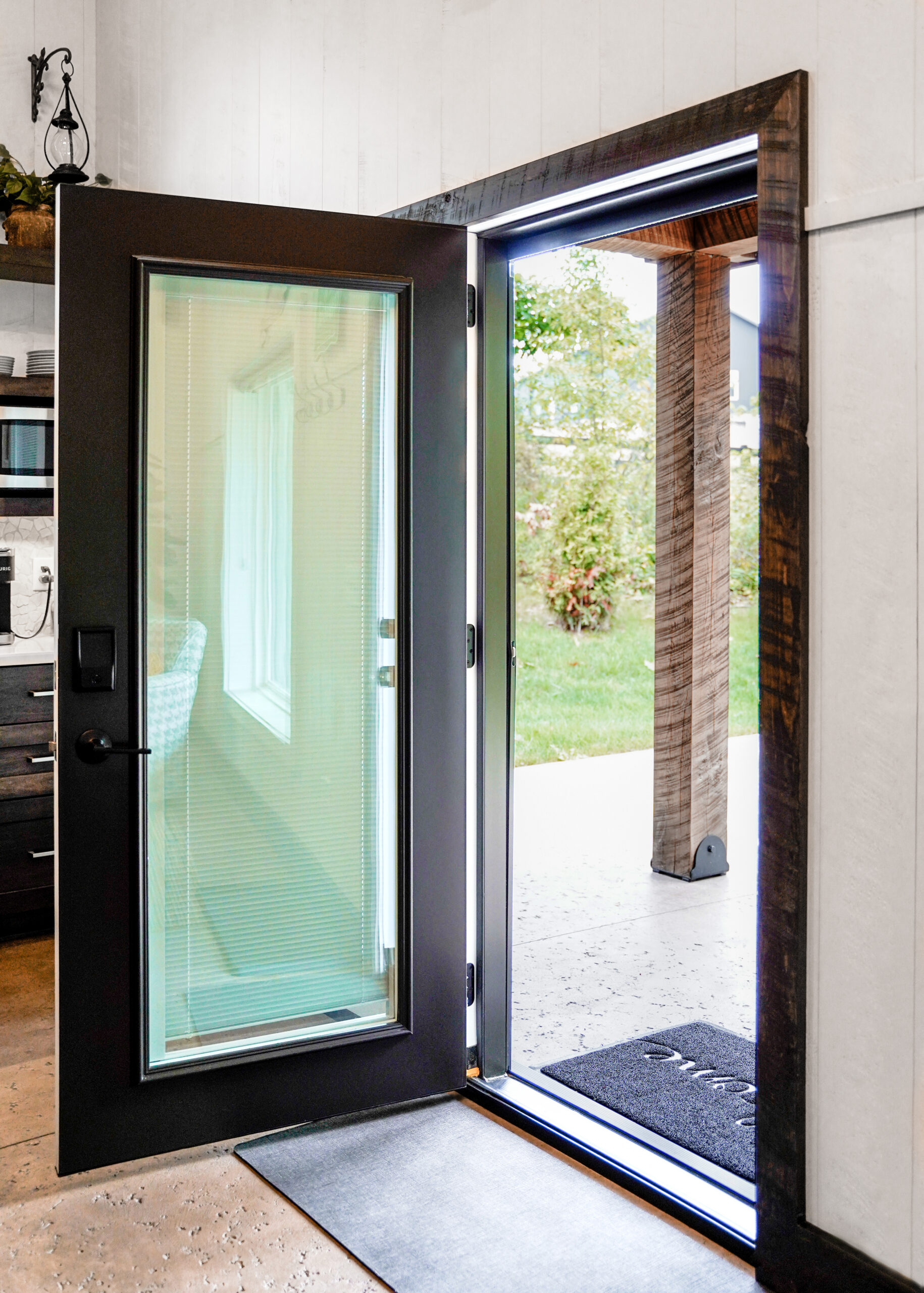 Open hinged patio door with internal blinds.