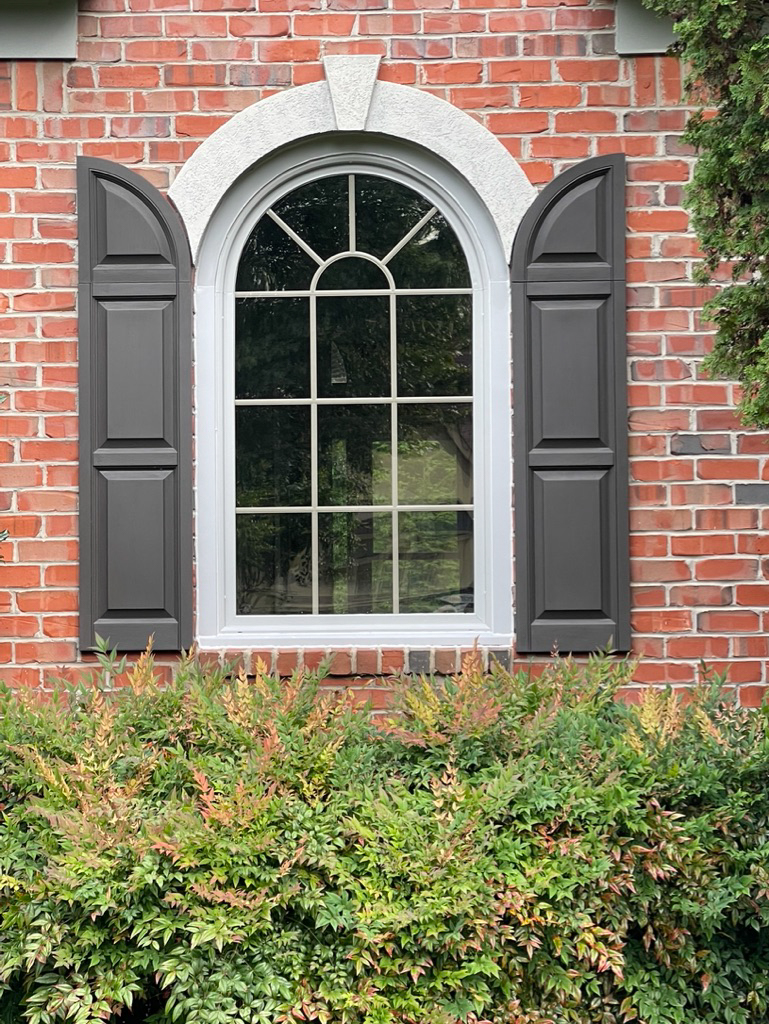 Round top window with sunburst grids.