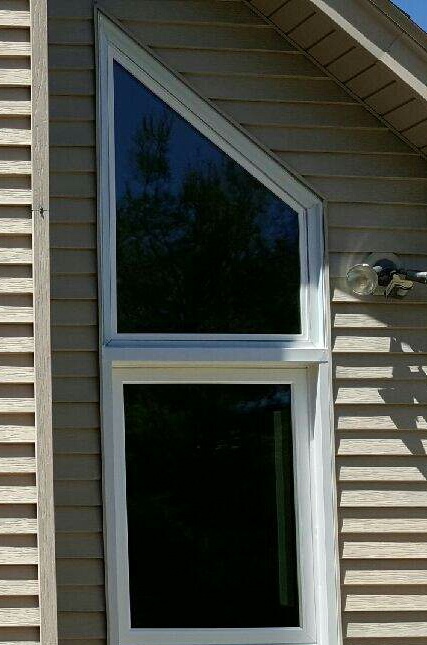 Trapezoid-shaped specialty window over a picture window.