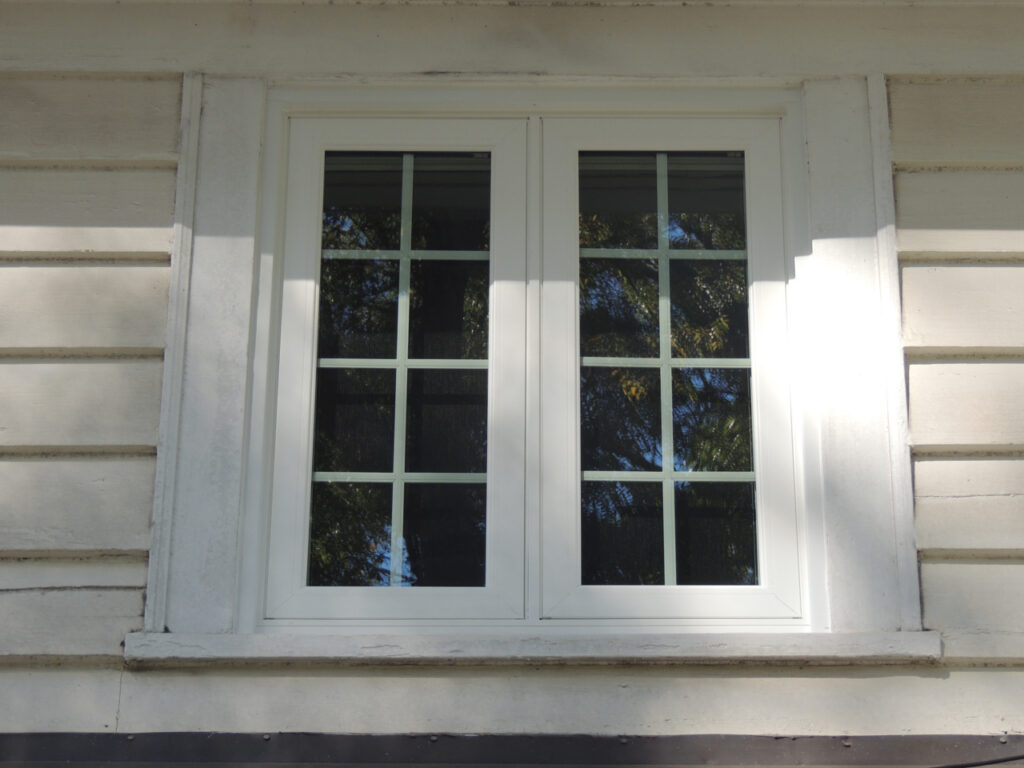 Double casement window with colonial grids.