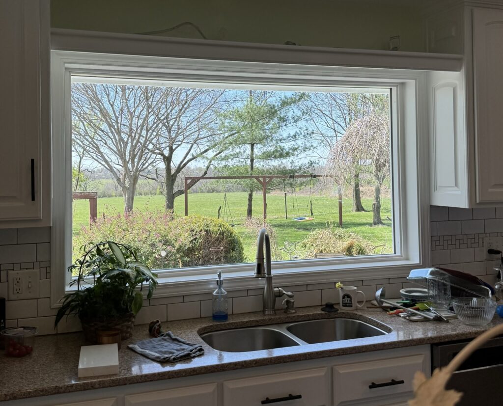 Large picture window above kitchen sink.