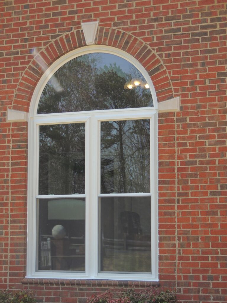 Half-round window above double-hung windows.