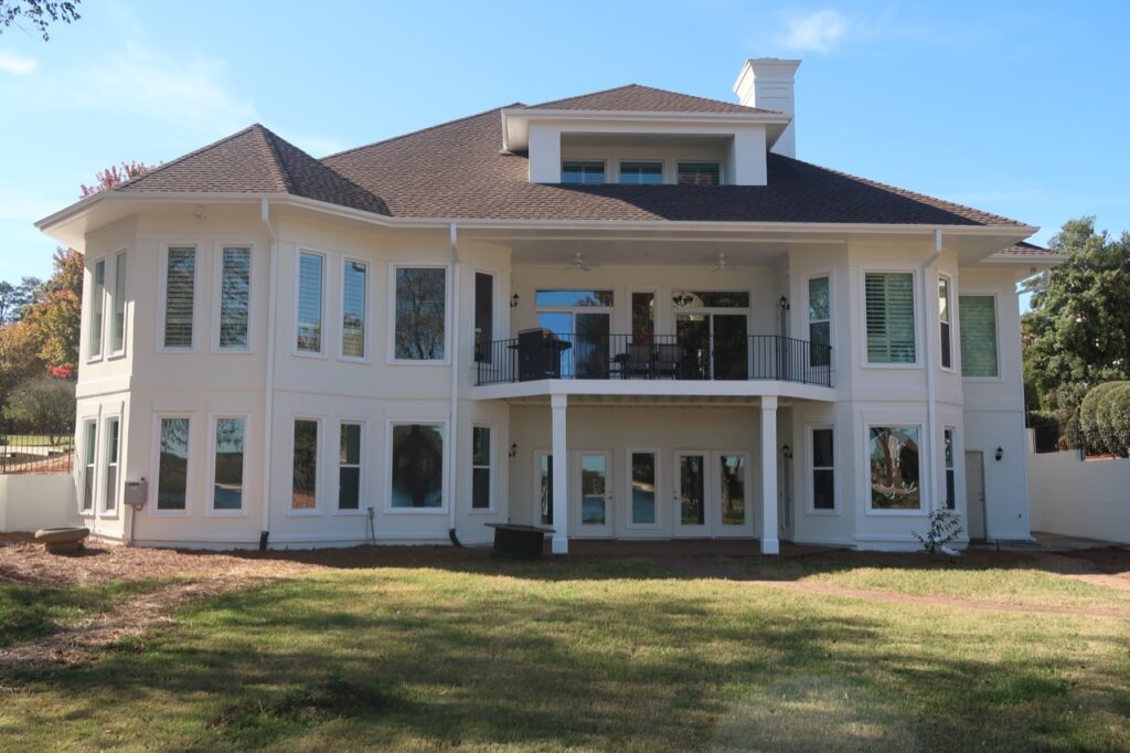 Tons of picture windows on the back of a home.