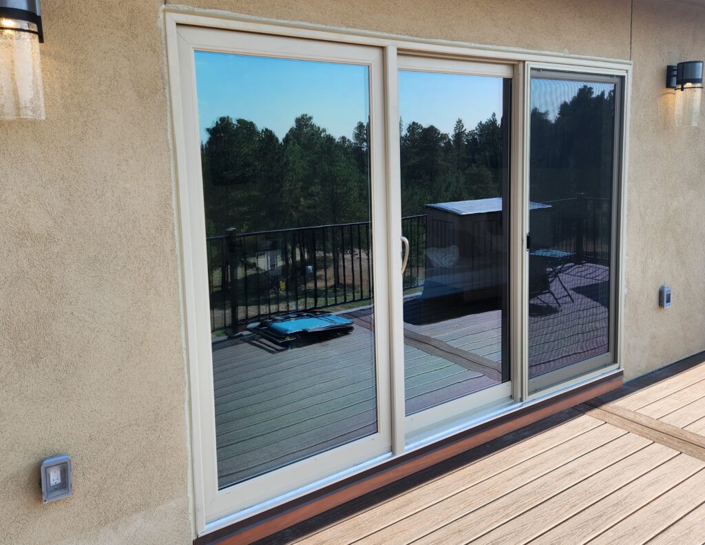 Exterior view of beige sliding glass door.