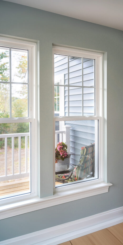 White Aspect double-hung windows with front porch view.