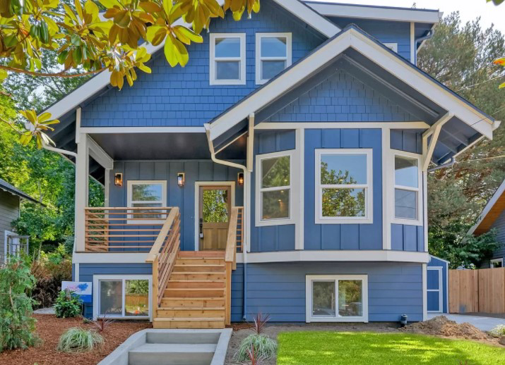 Blue house with sliding windows on the bottom right.