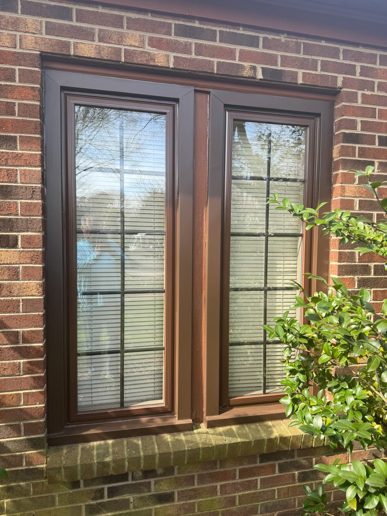 Brown casement windows with grids.