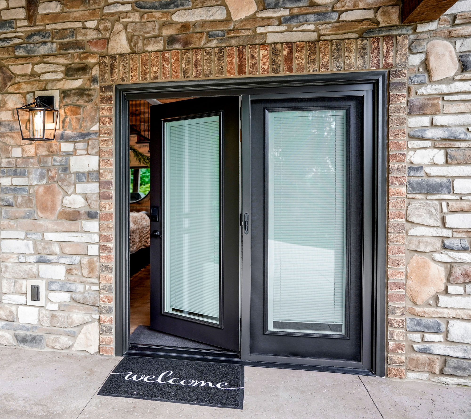 Open legacy hinged patio door in rustic bronze.