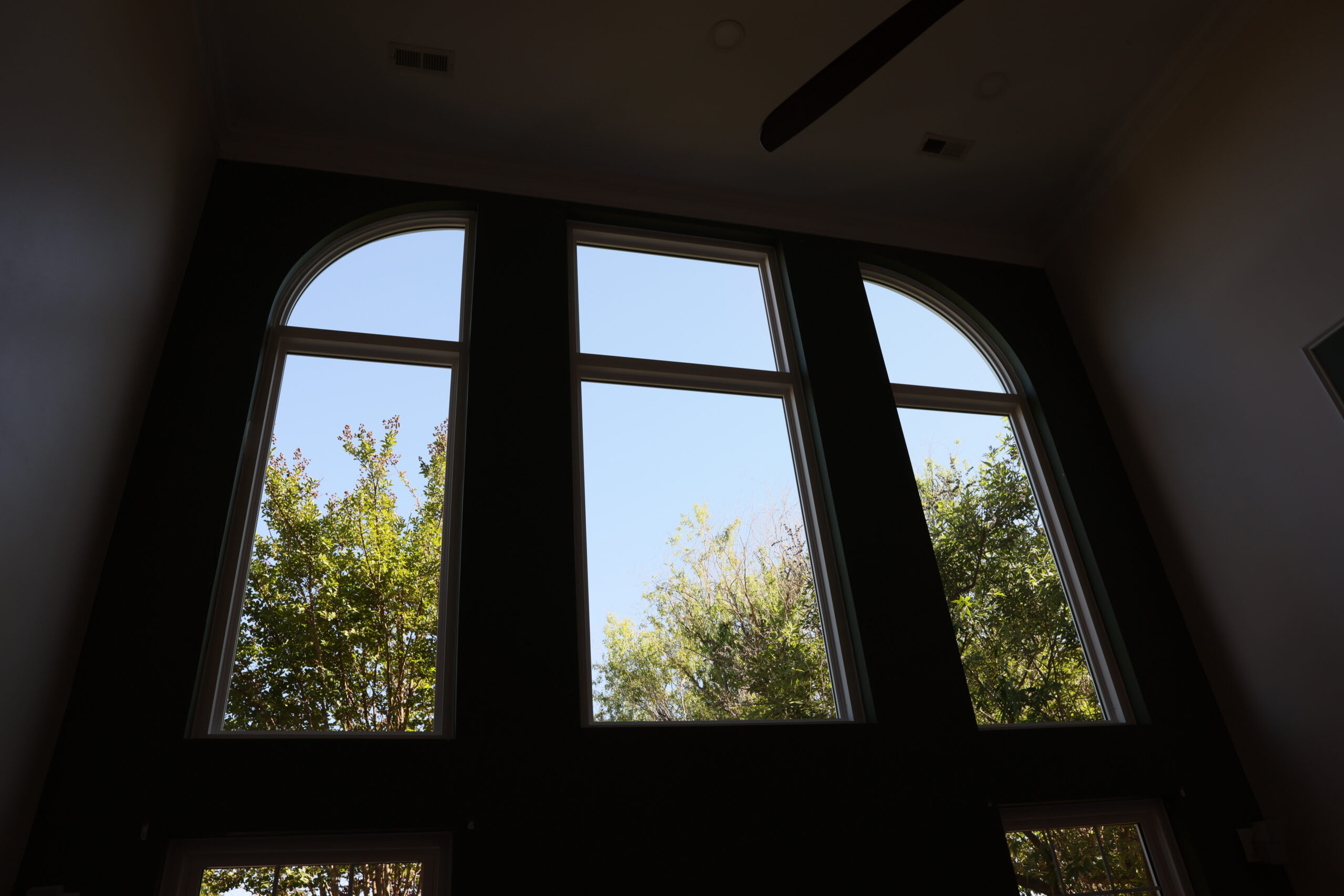 Quarter-round windows above picture windows.