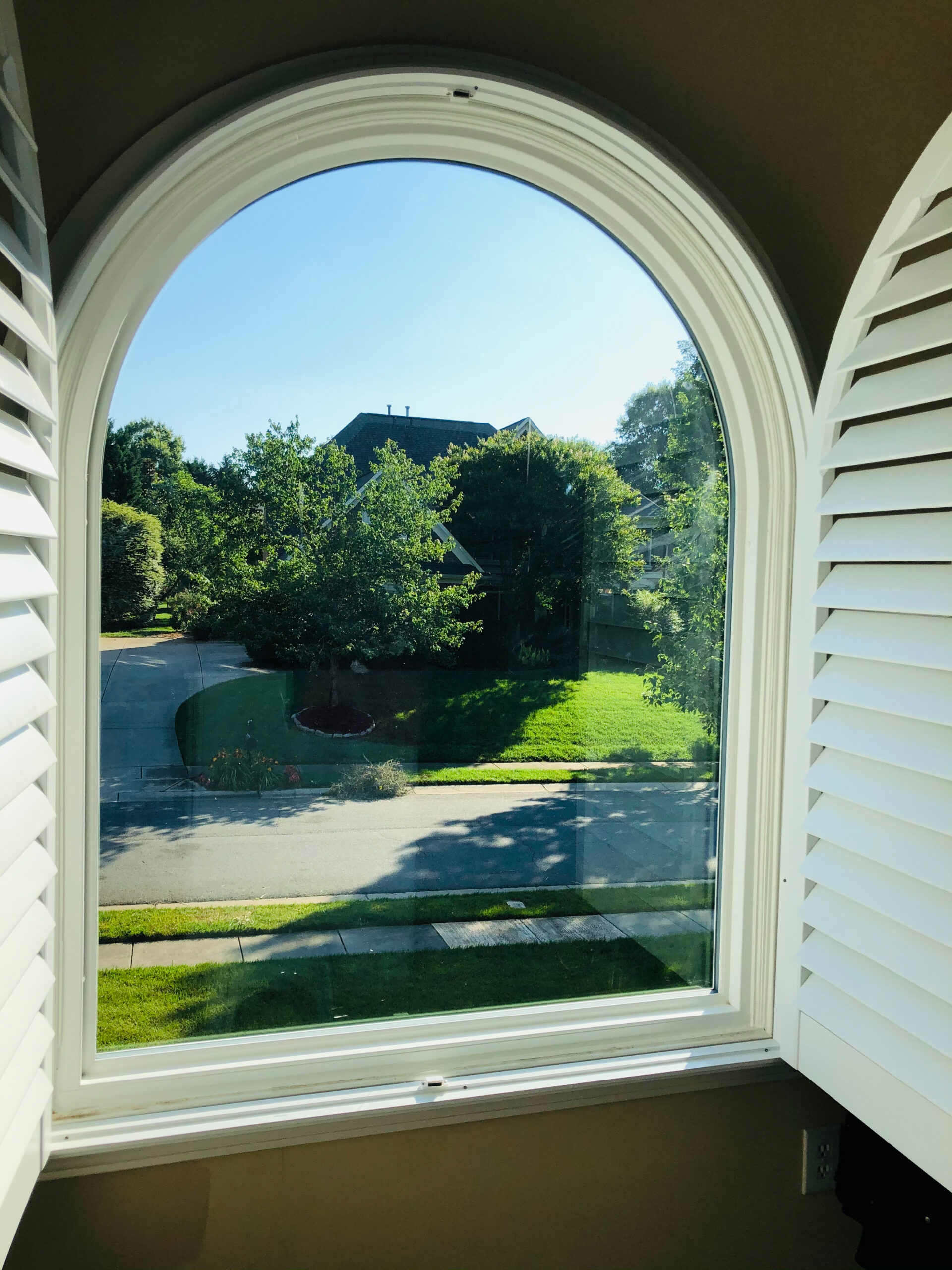 White round top window with shutters.