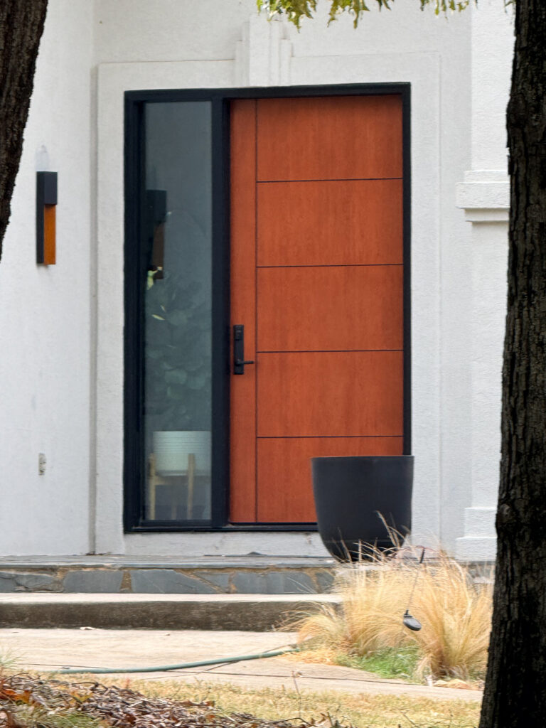 Inscribed entry door with side lite panel.