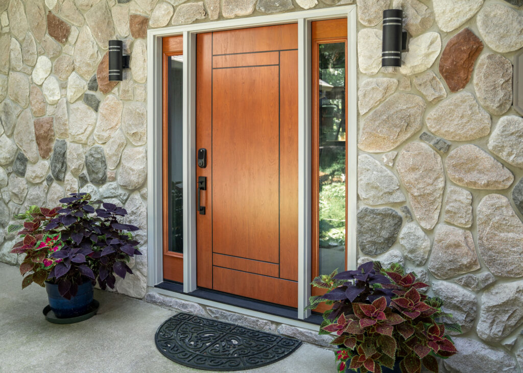 Signet inscribed entry door with side lites.