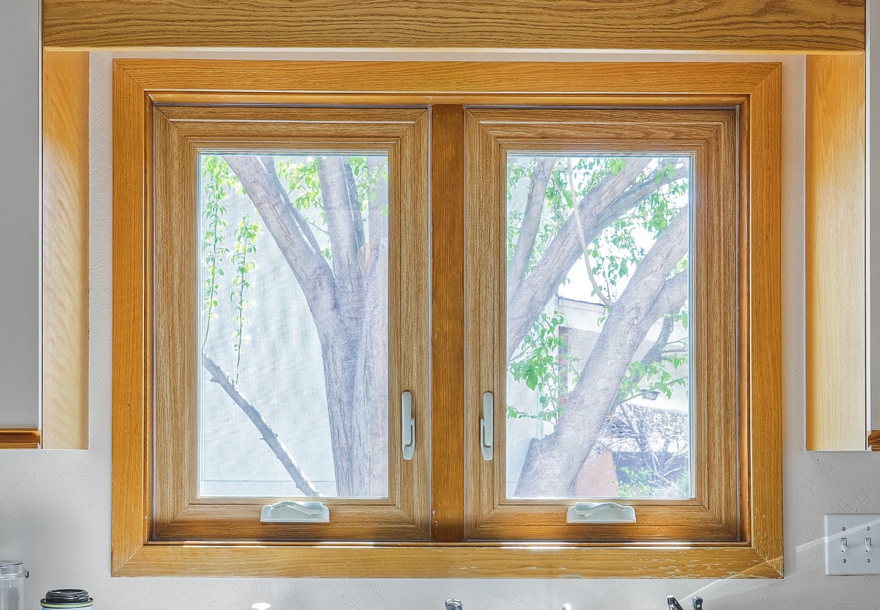 Before-and-after image illustrating the dramatic improvement in a home's curb appeal after replacing old, foggy windows with modern, clean Zen Windows products.