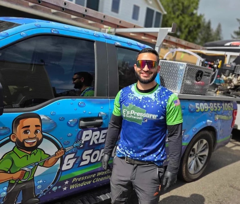 E's Pressure & Softwash team member beside the service truck
