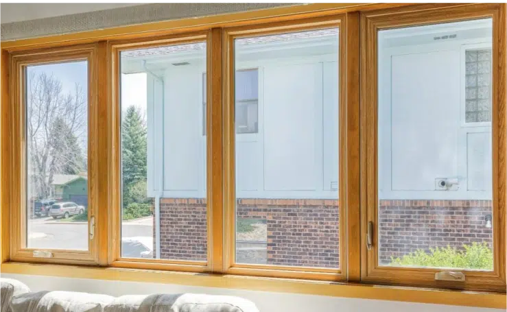 Homeowner opening a bright replacement window